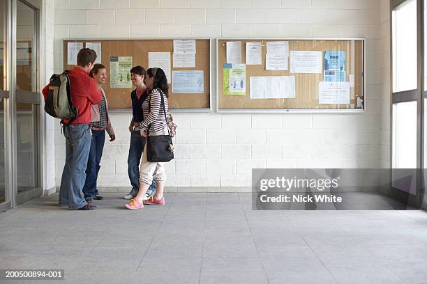 young adults by notice boards - vetrinetta foto e immagini stock