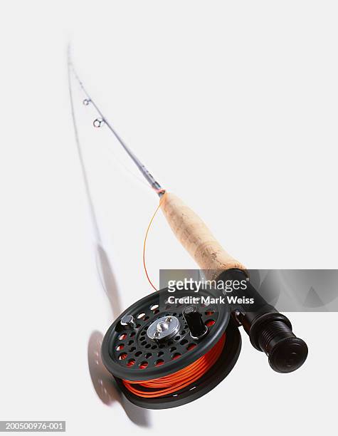 fishing rod and reel with red line - fishing reel foto e immagini stock