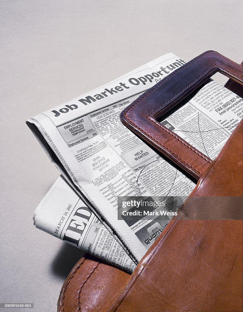 Newspaper employment classified ads in briefcase
