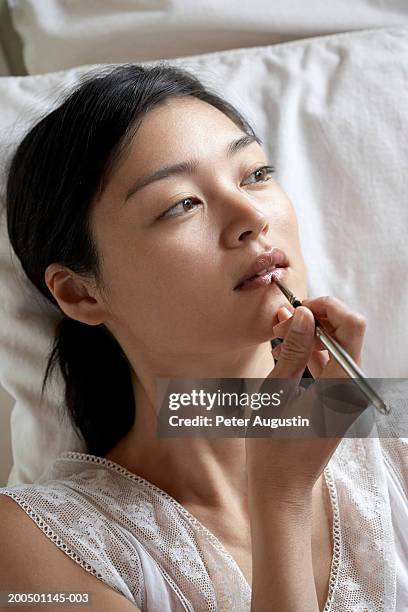 woman using lip pencil - konturstift stock-fotos und bilder