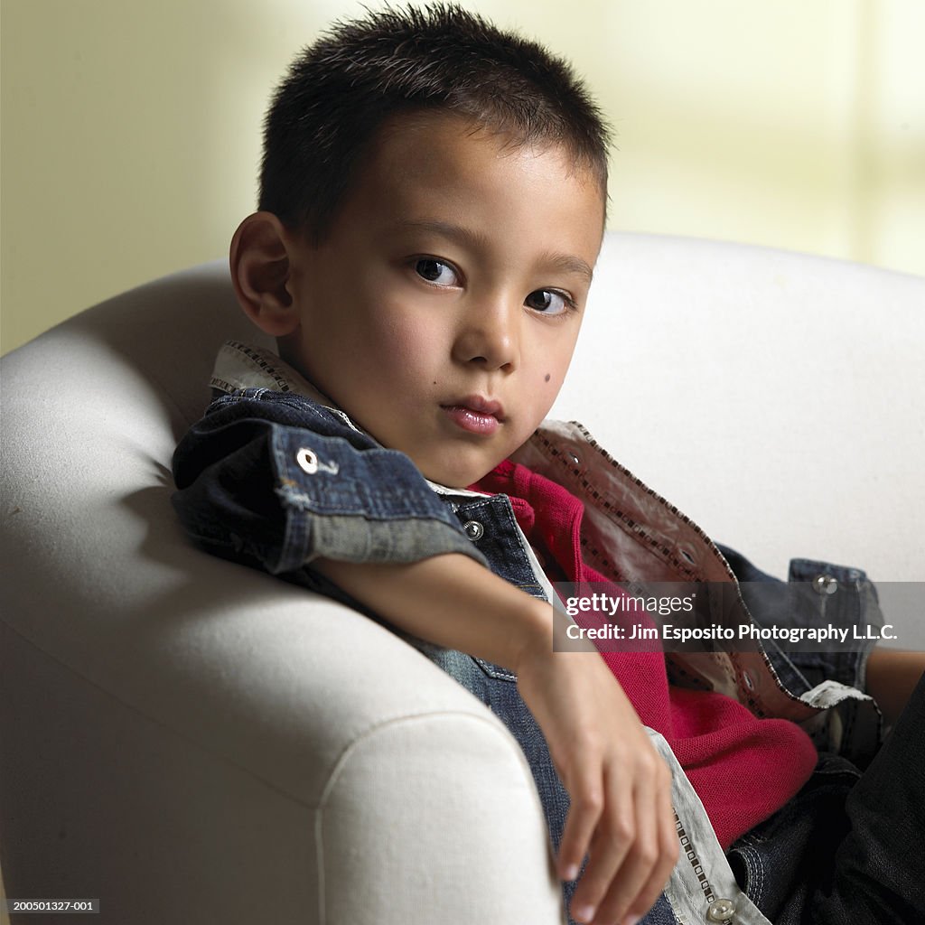 Boy (6-8) in chair, portrait