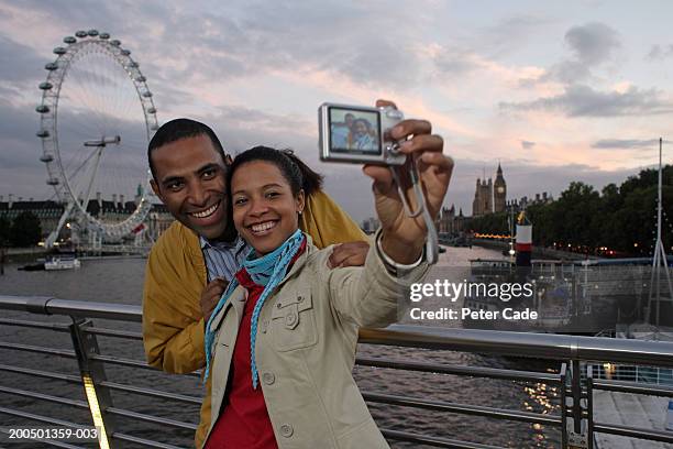 england, london, couple taking photo of themselves - millennium wheel stock pictures, royalty-free photos & images