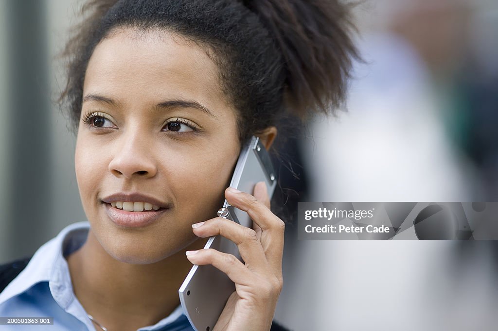 Young woman using mobile phone, close-up