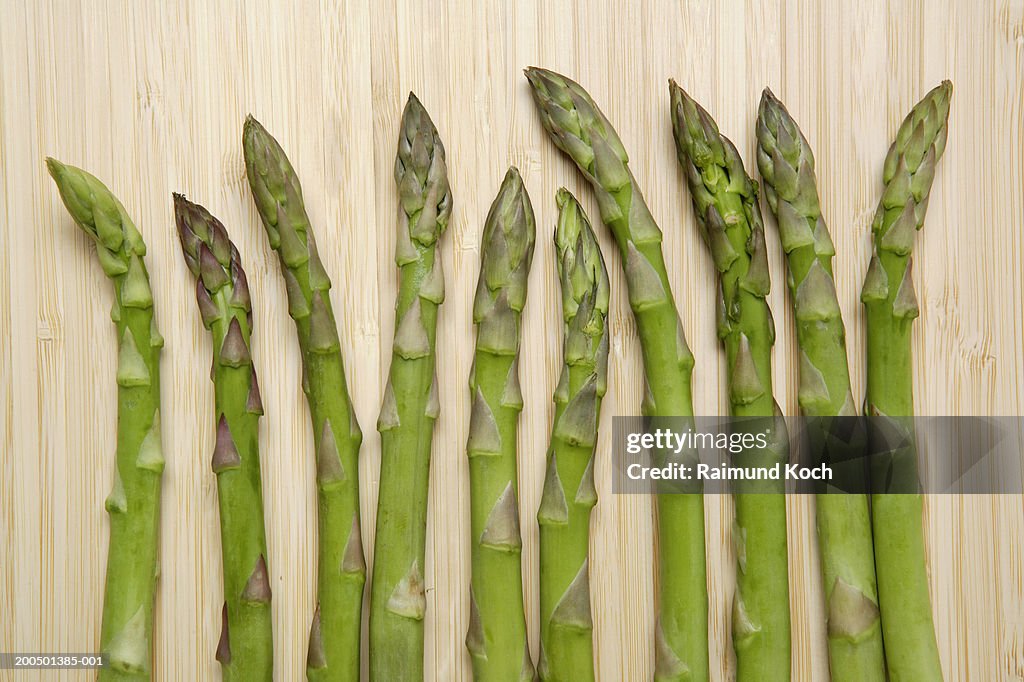 Organic asparagus on bamboo cutting board