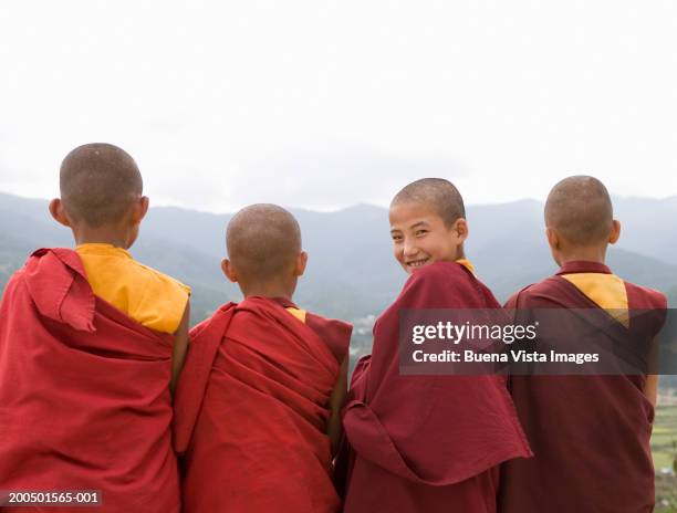 bhutan, bumthang, karchu dratsang monastery, four monks - bhutan monk stock pictures, royalty-free photos & images