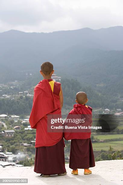 bhutan, bumthang, karchu dratsang monastery, buddhist monks, rear view - bhutan monk stock pictures, royalty-free photos & images