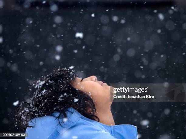 girl (5-7) letting snowflakes fall on face, eyes closed, side view - girl looking down stock pictures, royalty-free photos & images