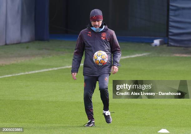 Pep Guardiola the manager of Manchester City juggles the ball during a training session at Etihad Campus ahead of their UEFA Champions League match...