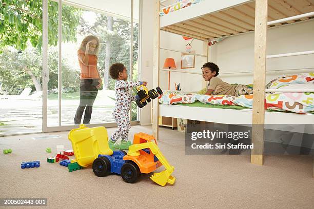 mother watching sons (2-8) playing in room - kids in bunk bed stock pictures, royalty-free photos & images