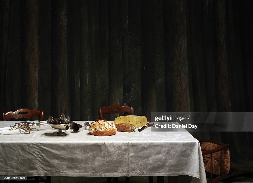 Dinner table with candle holder knocked over