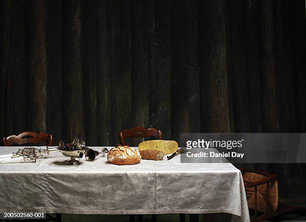 dinner table with candle holder knocked over - still life foto e immagini stock