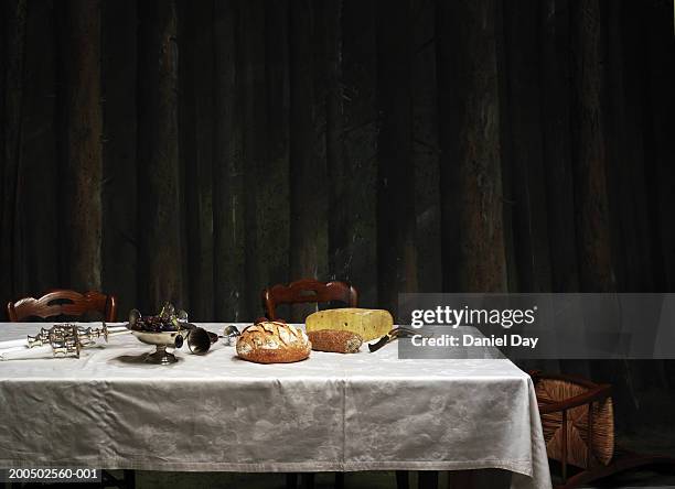 dinner table with candle holder knocked over - still life - fotografias e filmes do acervo