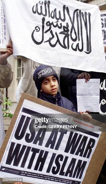 Young boy holds a placard as protesters belonging to the Al- Muhajiroun chant anti US slogans, and show their support to Osama Bin Laden and the...