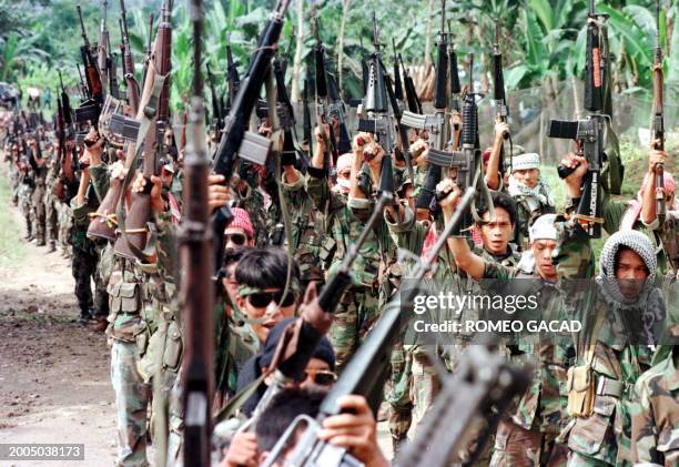 Photo dated 27 February 1999 shows some 700 fully armed secessionist Moslem rebels of the Moro Islamic Liberation Front brandish their weapons during...