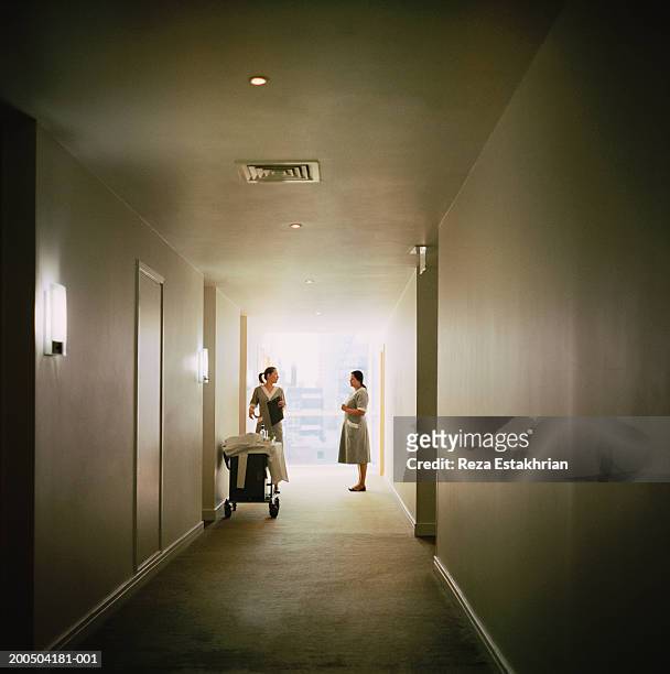 hotel cleaning staff in hallway - hotel housekeeping stock pictures, royalty-free photos & images