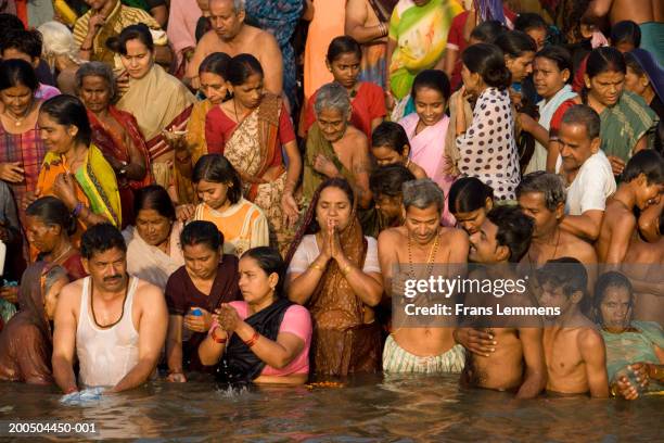 hindu pilgrims bathing and worshipping in ganges river - ganges river stock pictures, royalty-free photos & images