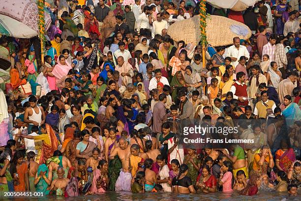 hindu pilgrims bathing and worshipping in ganges river, elevated view - semi dress stock pictures, royalty-free photos & images