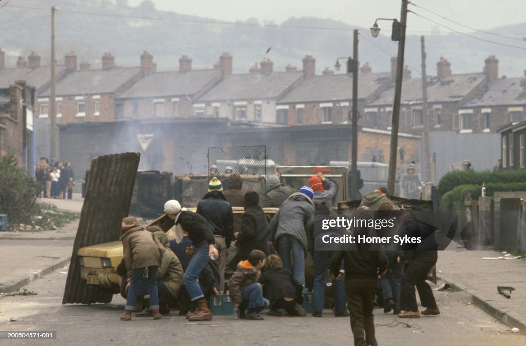 United Kingdom, Northern Ireland, Belfast, Group of youths burning hijacked car in street