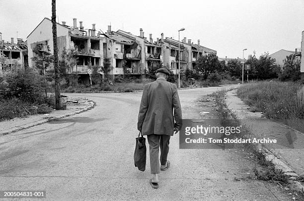 Bosnia, Sarajevo A man walks through a deserted street towards his house in a heavily bomb damaged area near Sarajevo airport. During the 47 months...