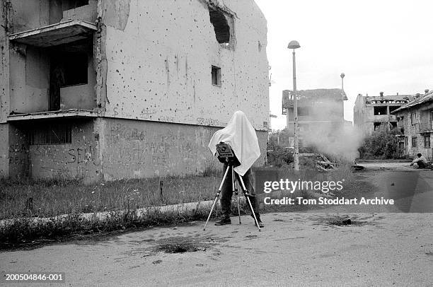 Bosnia, Sarajevo Photographer documents war damage on a large format camera in a devastated suburb of Sarajevo. During the 47 months between the...