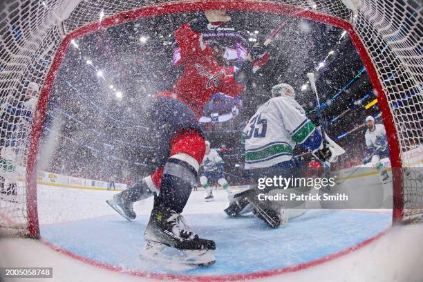 Tom Wilson of the Washington Capitals collides into the goal in front of goalie Thatcher Demko of the Vancouver Canucks during the second period at...