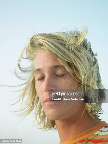 young man outdoors, eyes closed, close-up - eyes closed stock-fotos und bilder
