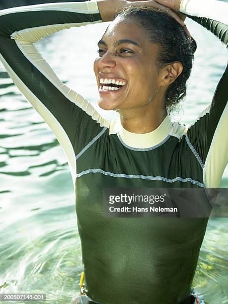 Young woman in sea, smiling