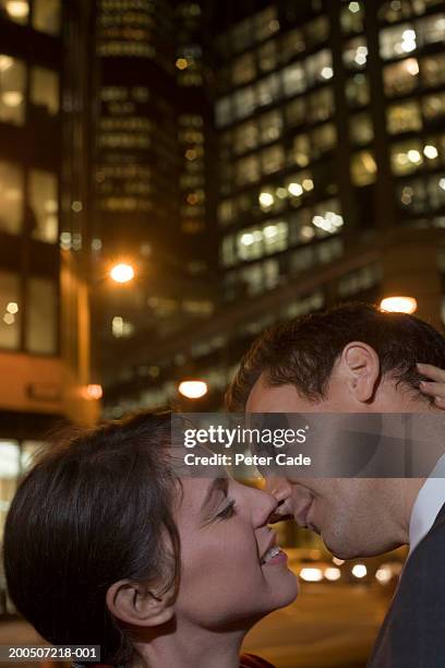 couple kissing on street, close-up, side view, night - couple close up street stock pictures, royalty-free photos & images