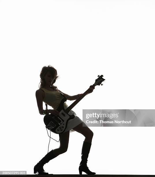 silhouette of young woman playing bass guitar - acoustic guitar white background stock pictures, royalty-free photos & images