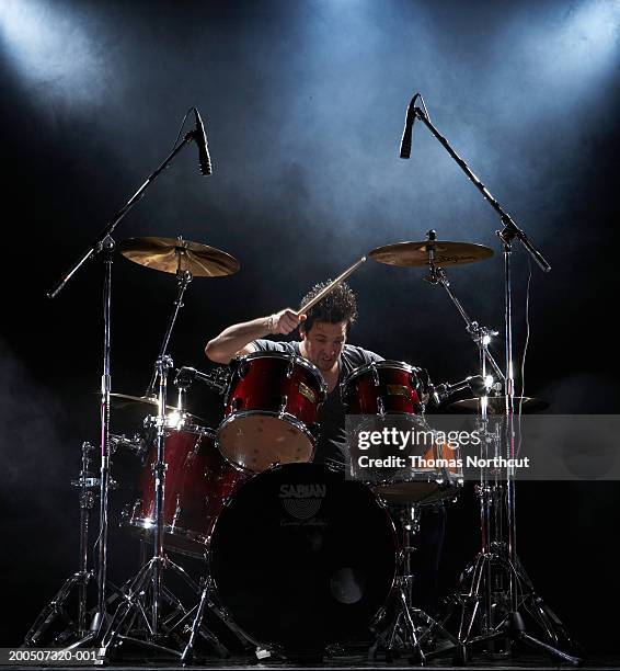 young man playing drums - drums stock pictures, royalty-free photos & images