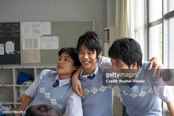 Teenage male students (14-17) with arms around each other
