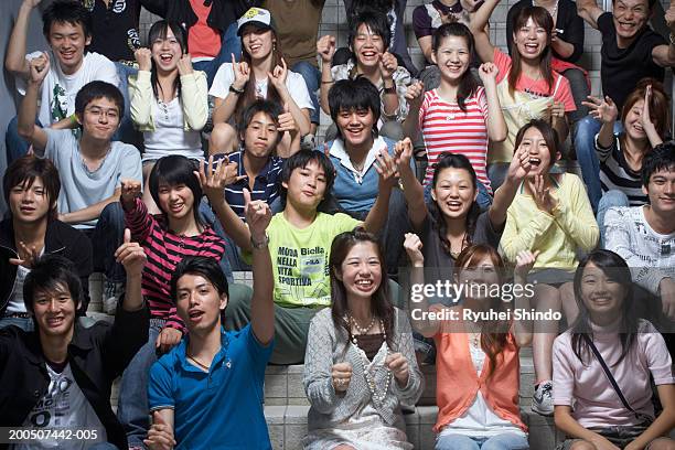 group of teenagers (13-18) sitting on steps, cheering - audience ストックフォトと画像