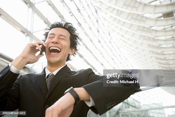 young businessman talking on cell phone, laughing, eyes closed - 24 h du mans bildbanksfoton och bilder