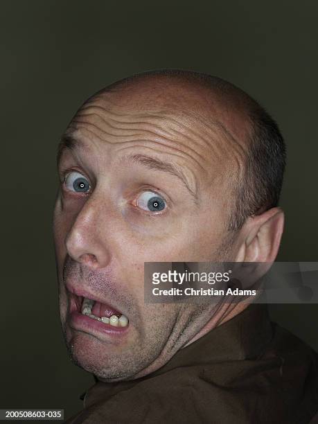 mature man making funny face, close-up, portrait - mann erschrocken stock-fotos und bilder