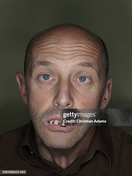 mature man wearing fake teeth, making funny face, close-up, portrait - ugly bald man stock pictures, royalty-free photos & images