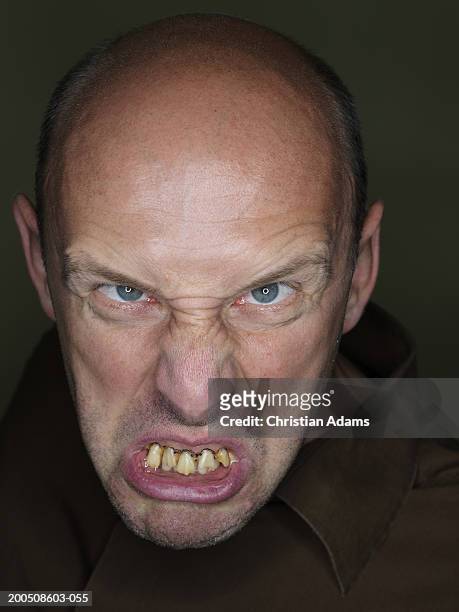mature man wearing fake teeth, making funny face, close-up, portrait - ugly bald man stock pictures, royalty-free photos & images