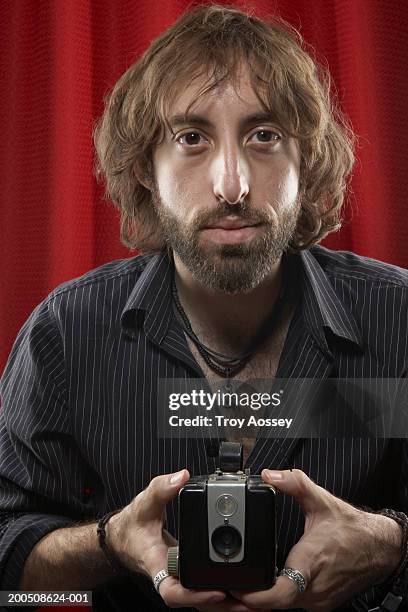 man holding camera, portrait, close-up - locket stock pictures, royalty-free photos & images