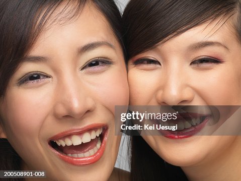 Two Young Women Cheek To Cheek Laughing Portrait High-Res Stock Photo ...
