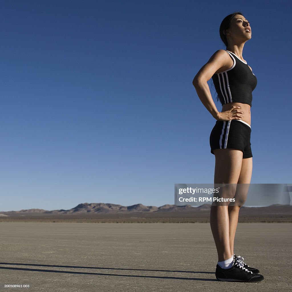 Woman resting in desert before run