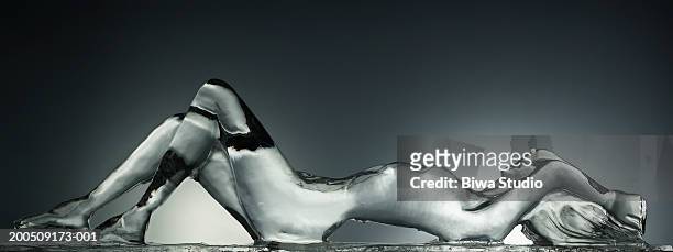 ice sculpture of naked woman - ice sculpture stock-fotos und bilder