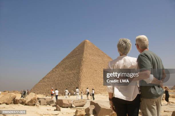 egypt, giza, mature couple looking at pyramid, rear view - egypt tourist stock pictures, royalty-free photos & images
