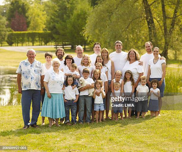 large family standing outdoors, smiling, portrait - large family stock pictures, royalty-free photos & images