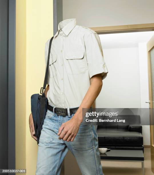 headless man walking out of room (digital enhancement) - headless stockfoto's en -beelden