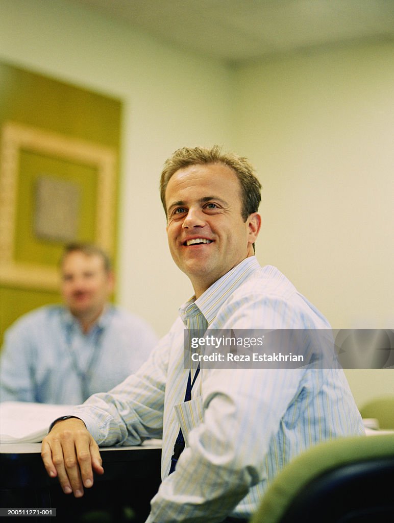 Businessman in meeting,  smiling