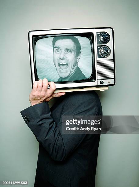 businessman carrying television on shoulder, face on screen, shouting - alter lustig crazy stock-fotos und bilder