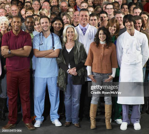 men and women in uniform standing with crowd, smiling, portrait - crowd stock pictures, royalty-free photos & images