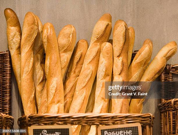 baguettes in basket in bakery - boulangerie paris stock pictures, royalty-free photos & images