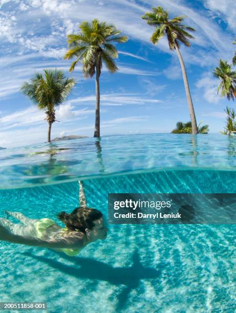 fiji, young woman swimming in pool, surface view - fiji stock pictures, royalty-free photos & images