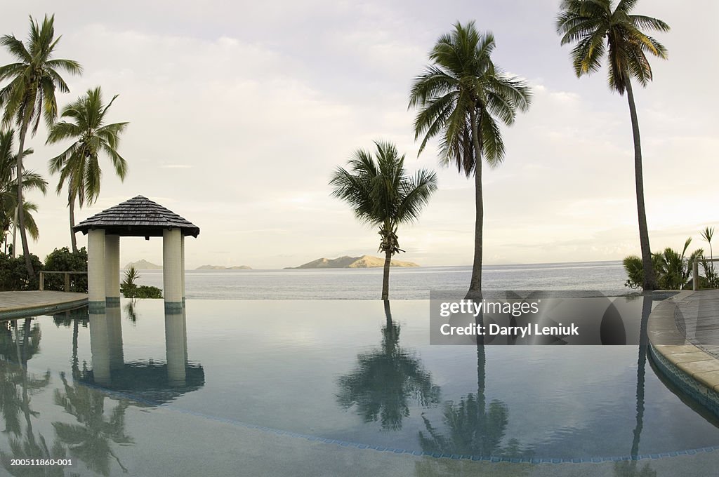 Fiji, Mamanuca Islands, Mana Island, infinity pool and sea at dawn