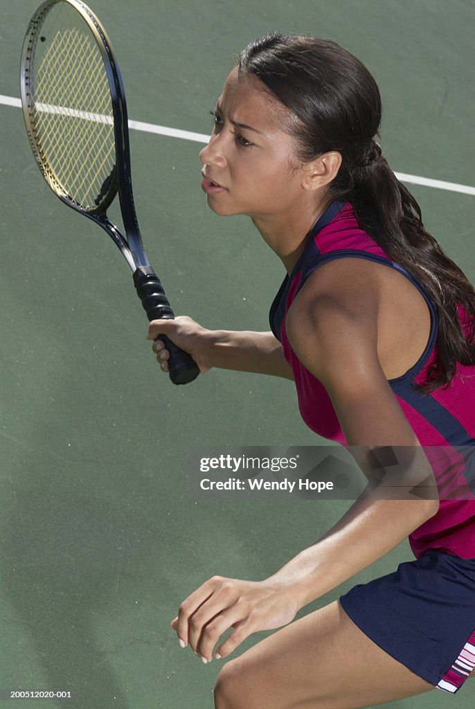 Woman holding tennis racket on court